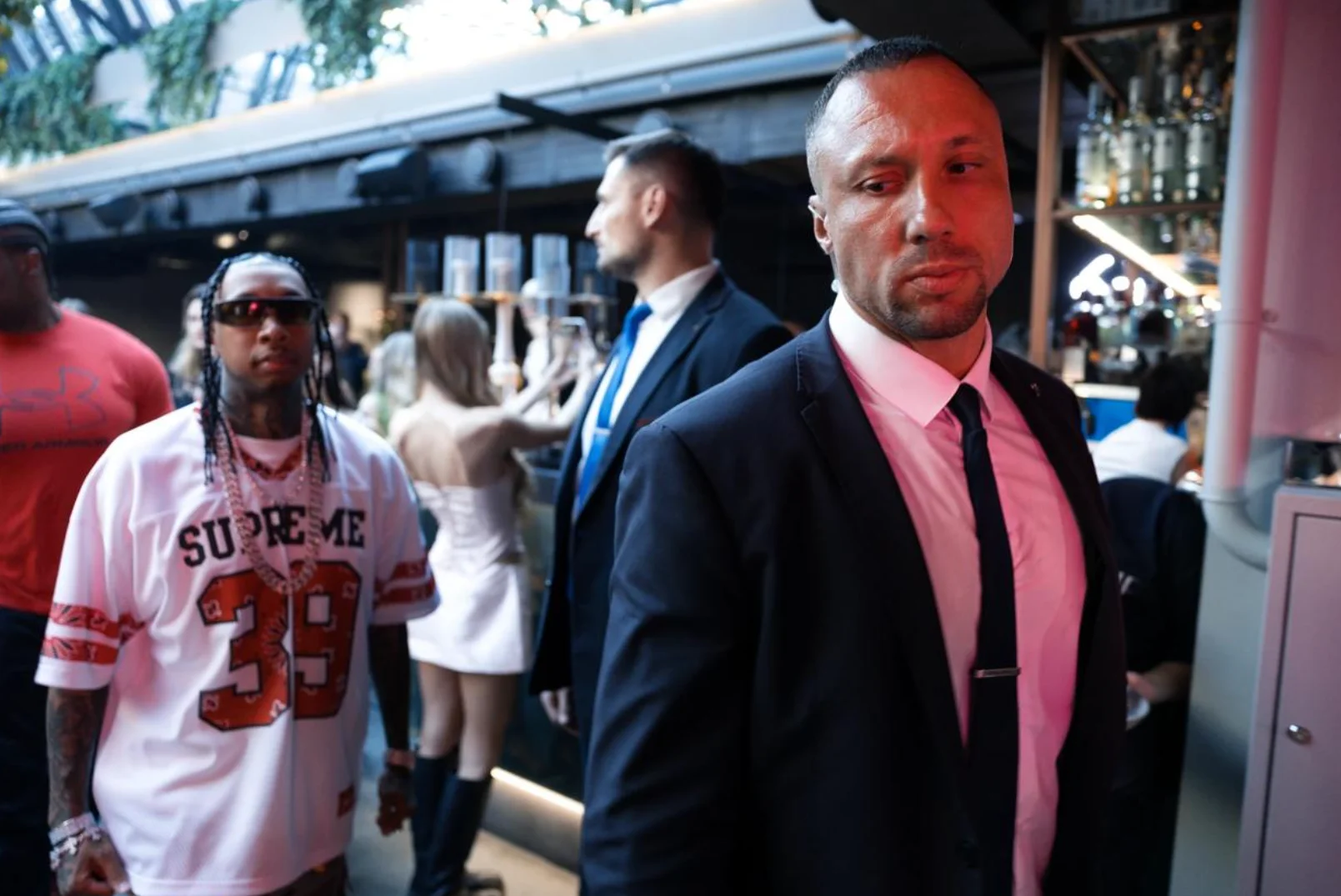 Man in a suit walking through a crowd