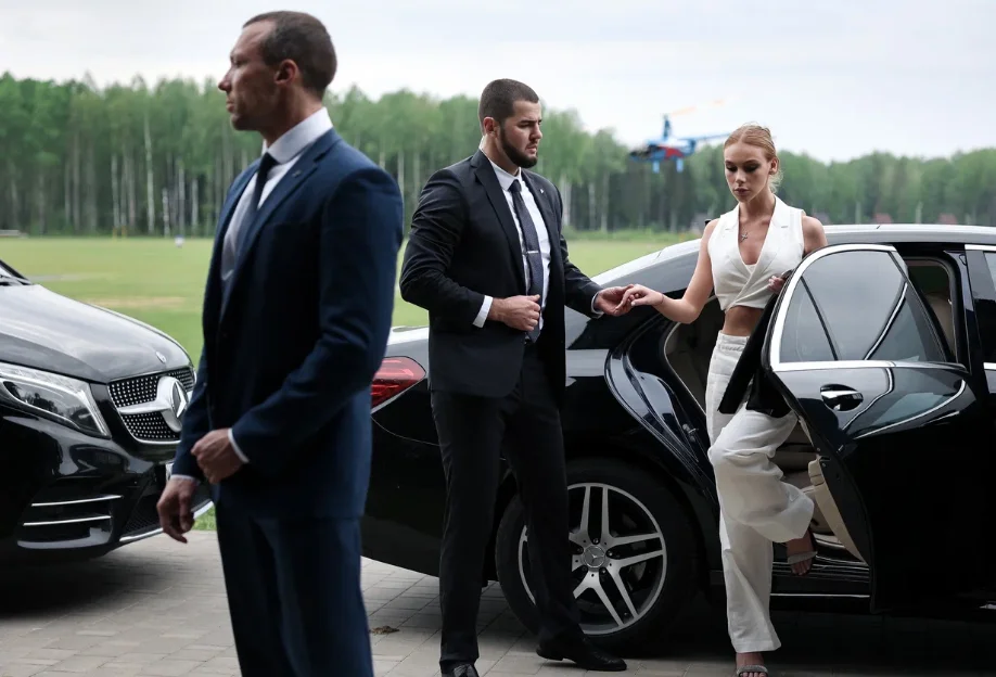 Security team standing beside a car